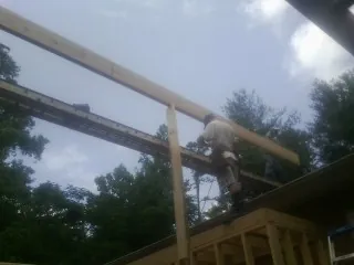 Carpenter setting a ridge beam over a new addition frame — Ice Dam Removal by Roofing Brothers in Nicasio