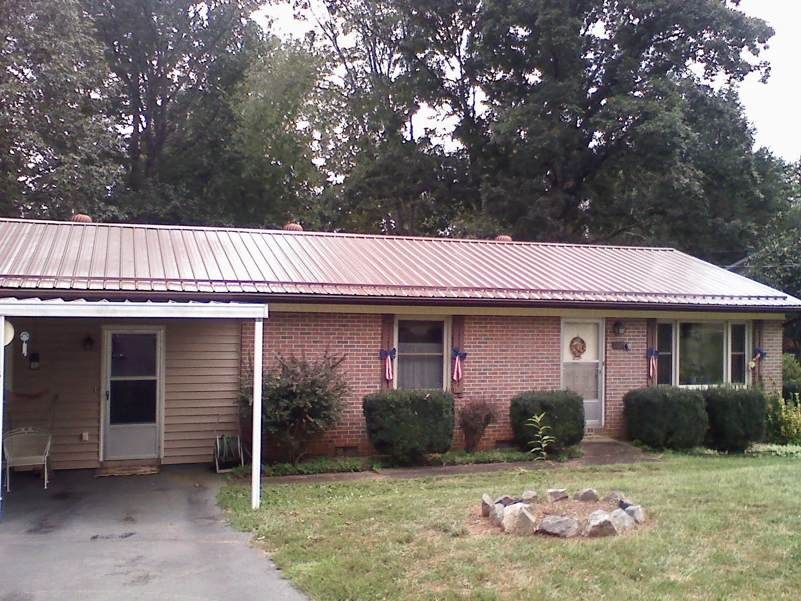 Bronze metal roof and carport on a brick ranch home — Roof Repair work by our crew in Nicasio